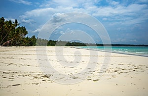 Untouched clean wide and long beach full of palms nobody around looks like a postcard in Kei islands, Maluku, Indonesia