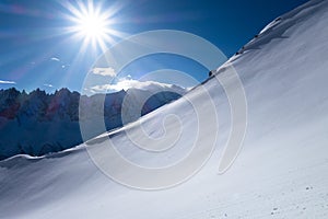 Untouched fresh powder slope in early winter bluebird day