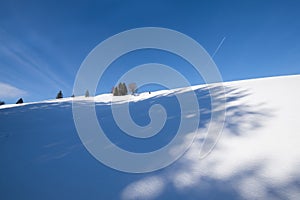 Untouched virgin snowy landscape with a blue sky in a frosty winter