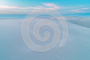 Untouched white sand dunes in early morning.