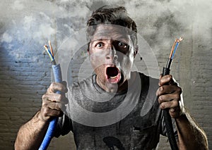 Untrained man joining electrical cable suffering electrical accident with dirty burnt face in funny shock expression