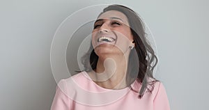 Untroubled indian woman laughs posing on grey background