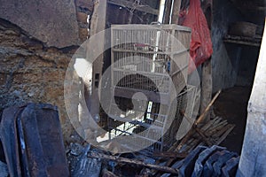 Unused bird cages piled up in a warehouse