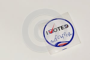 Unused I Voted sticker on a white table with copy space.
