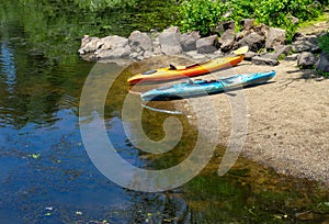 Unused kayaks by waters edge