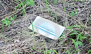 Unused mask on greenery in nature