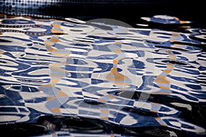 Unusual abstract colored reflections on pool water photo