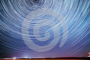 Unusual Amazing Stars Effect In Sky. Trace Of Moon. Spin Of Star And Meteoric Trails On Night Sky. Moonrise Sky Natural