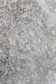 An unusual background of gray ice with bubbles. An abstract picture of frozen water, texture.