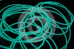 Unusual bright wires made of turquoise-colored material glowing at night.