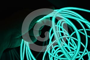 Unusual bright wires made of turquoise-colored material glowing at night.