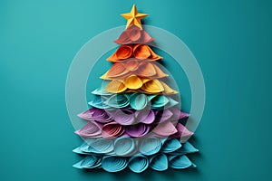 An unusual Christmas tree made of paper on a blue background. Festive mood and expectation of a miracle