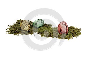 Unusual colourful vintage Easter eggs lying on moss.