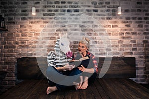 Unusual couple reading a book in stylish apartment