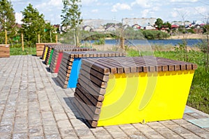 Unusual decorative wooden bench in the city park near river