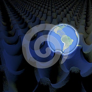 Unusual depiction of glowing planet earth in an egg carton box, south america in view