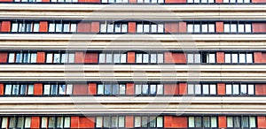 Unusual facade of a high-rise building with red walls.