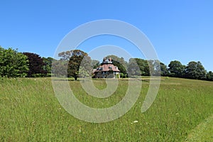 Unusual historic sixteen sided house set in acres of grassland on a beautiful sunny summers day in Devon, England