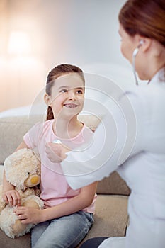 Optimistic girl admiring female doctor