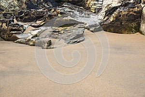 Unusual landscape image giving an abstract look of small scale rocks in beach as large cliffs and plains with lovely sand texture