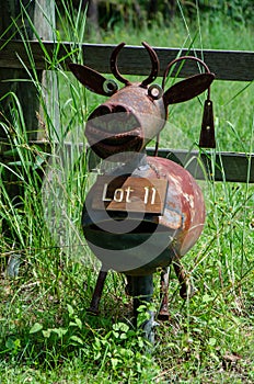 An unusual metal cow letter box outside a lot entrance
