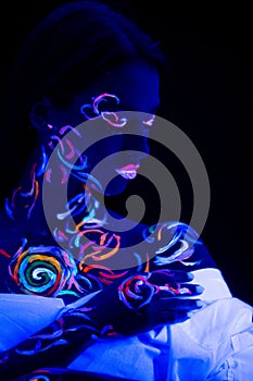Unusual modern shot of woman with fluorescent body art