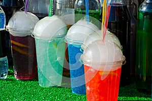 Unusual multi-colored cocktails with carbon dioxide or dry ice sold on a holiday in the park