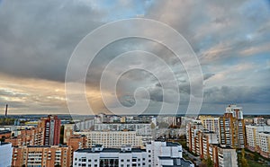 Unusual multicolored clouds over the city during sunset. Clouds over high-rise residential buildings in a residential area of the