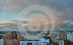 Unusual multicolored clouds over the city during sunset. Clouds over high-rise residential buildings in a residential area of the