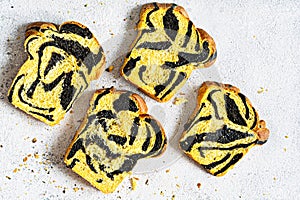 Unusual pumpkin marbled tiger print bread with cuttlefish ink, braided on a light background.