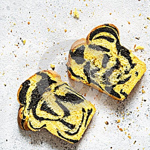 Unusual pumpkin marbled tiger print bread with cuttlefish ink, braided on a light background.