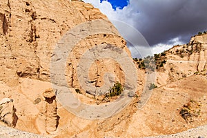 Close up of triangular rock formations against grey dark sky in Kasha-Katuwe Tent Rocks National Monument in New Mexico