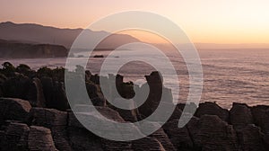 Unusual rock formations on oceanÂ´s coast shot during sunset