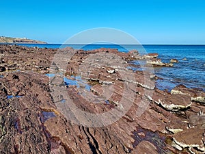 Unusual rock structure against the sea water background, interesting geological object at Hallett Cove, Australia