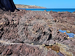 Unusual rock structure against the sea water background, interesting geological object at Hallett Cove, Australia