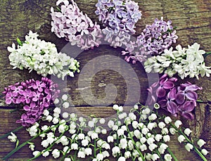 Unusual round frame of lilac and lily of the valley.