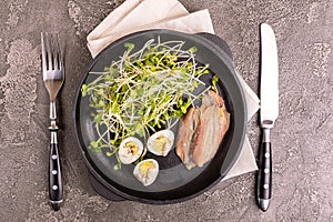 Unusual salad with leek sprouts, quail eggs and anchovies