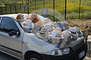 Unusual sales stall, hats for sale placed on a car