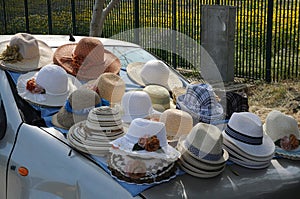 Unusual sales stall, hats for sale placed on a car