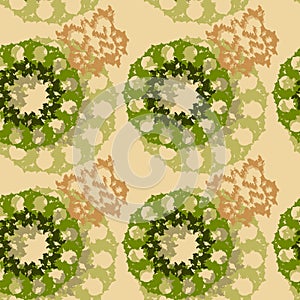 An unusual seamless pattern in the form of green and brown figures on a beige background