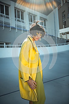 Unusual sloppy woman with wild hair wearing oversized coat