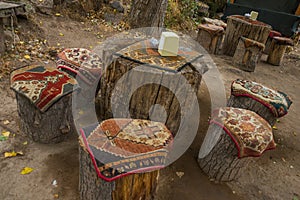 Unusual tables and chairs made of hemp, on top of traditional Cape carpets with a pattern. Cappadocia, Turkey