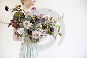 Unusual wedding stylish bouquet in hands of a bride