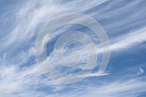 Unusual white striped wavy clouds in a bright blue sky. Heavenly background for your photos. Perfect Sky photo