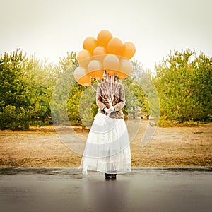 Unusual woman with balloons as concept outdoors