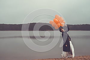 Unusual woman with balloons as concept outdoors