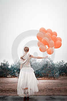 Unusual woman with balloons as concept outdoors