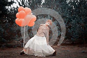 Unusual woman with balloons as concept outdoors