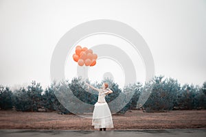 Unusual woman with balloons as concept outdoors