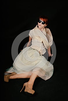 Unusual woman studio with red hair and sunglasses